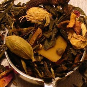 A close-up of mixed dried herbs and spices in a bowl.