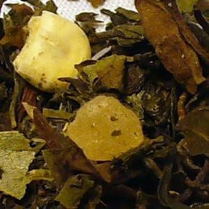 Close-up of dried tea leaves with a piece of dried ginger.