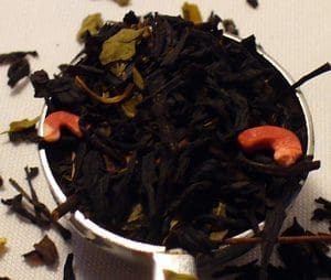 Close-up of loose black tea leaves with dried fruit pieces.
