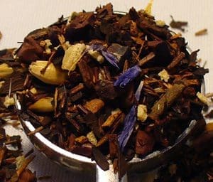 Close-up of a bowl filled with colorful mixed dried herbs and flowers.