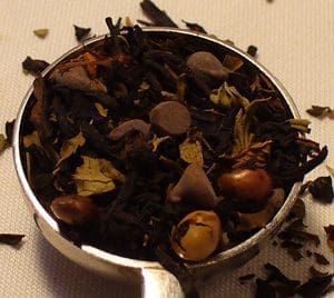 Herbal tea blend in a metal scoop.