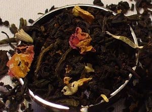 Close-up loose black tea with rose petals