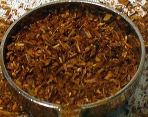 Close-up of a pan filled with cooked shredded meat.