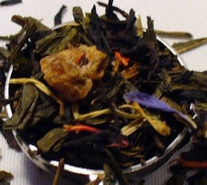 Close-up of loose leaf tea with dried flower petals and fruit pieces.