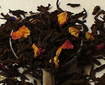 Close-up of loose black tea leaves with dried flower petals.