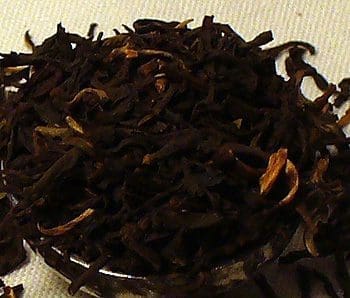 Close-up of dried black tea leaves with golden tips.
