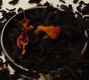 Close-up of loose leaf tea with flower petals in a bowl.